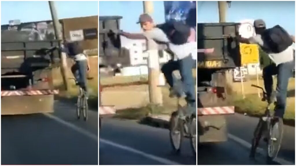 Motorista flagra homem em pé na sua bicicleta pegando uma carona em um caminhão