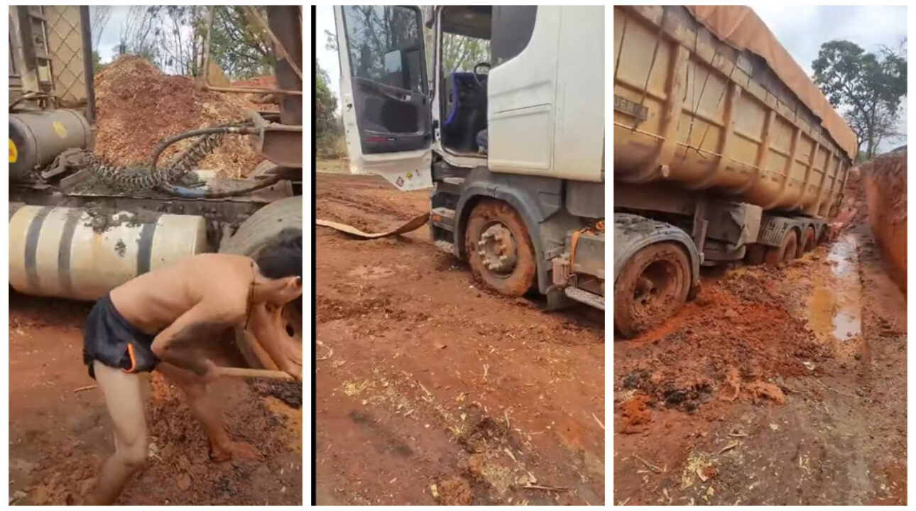 Caminhoneiro tenta desatolar caminhão com enxada em estrada com péssima condição 