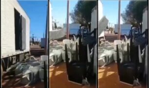 Caminhoneiro descarrega carga em frente a estabelecimento em Palmas (TO)