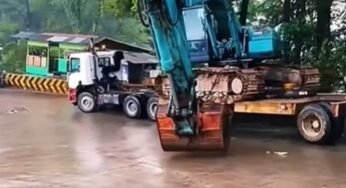 Caminhoneiro usa física a seu favor para conseguir trafegar com escavadeira hidráulica