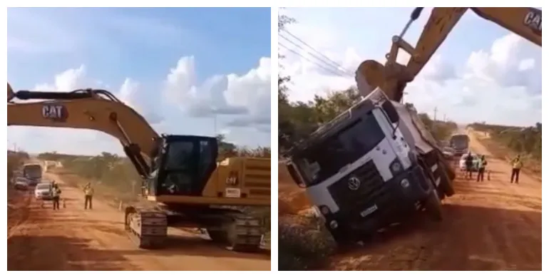 Escavadeira destombando caminhão no talento